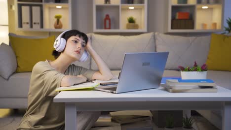 Depressed-young-woman-listening-to-music-at-home-at-night.